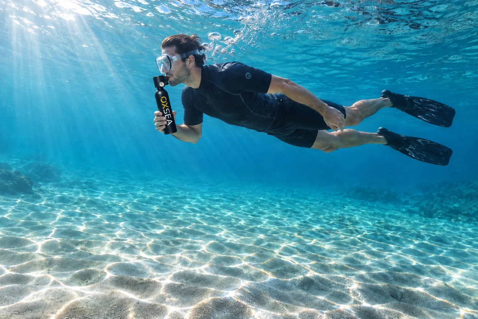 A diver explores the clear seabed with a mouth-held OX500 and its built-in regulator.